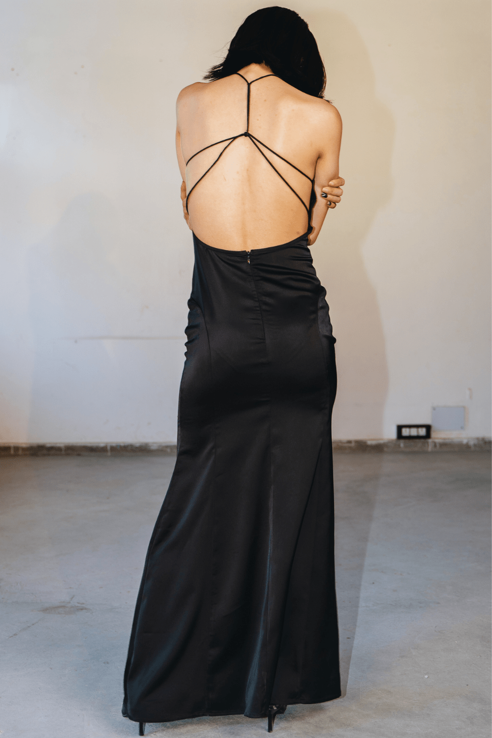 Woman wearing a black maxi dress – elegant evening and party wear by Beeglee