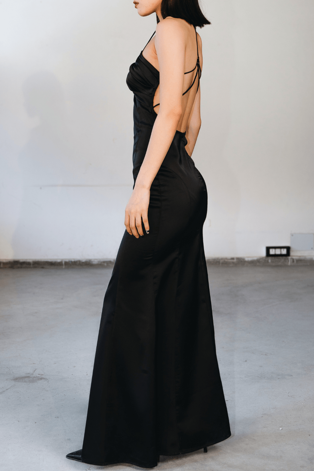 Woman wearing a black maxi dress – elegant evening and party wear by Beeglee