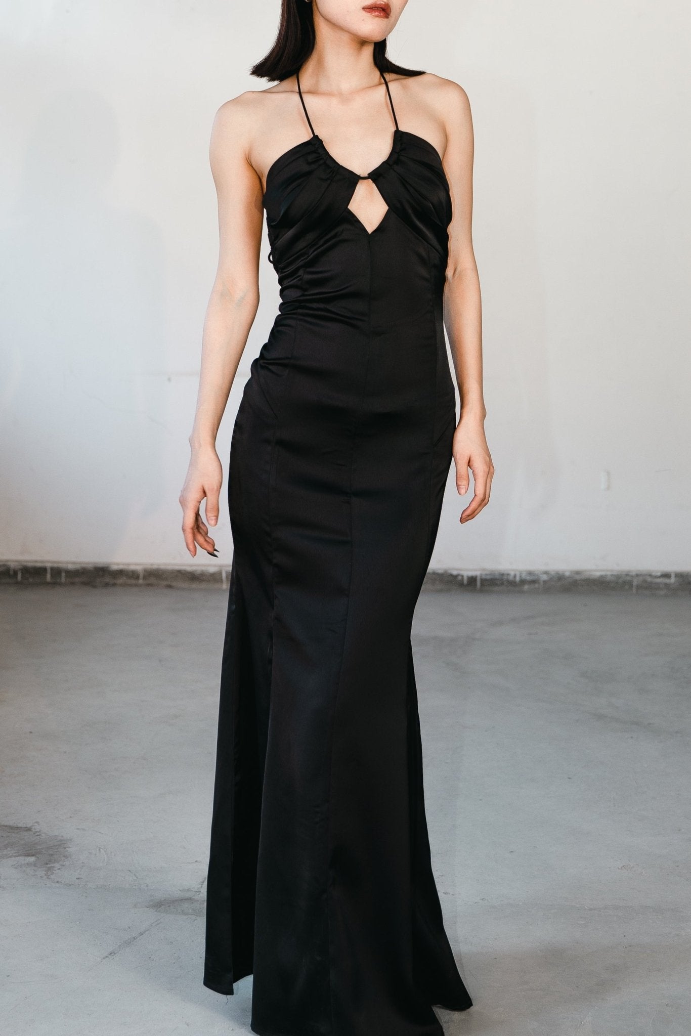 Woman wearing a black maxi dress – elegant evening and party wear by Beeglee