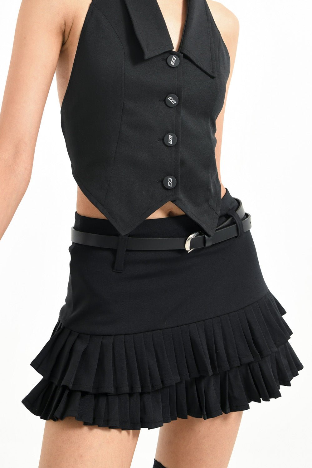 Woman wearing black chilling mini skirt for women by Beeglee – fitted waist and A-line silhouette with pleated design.