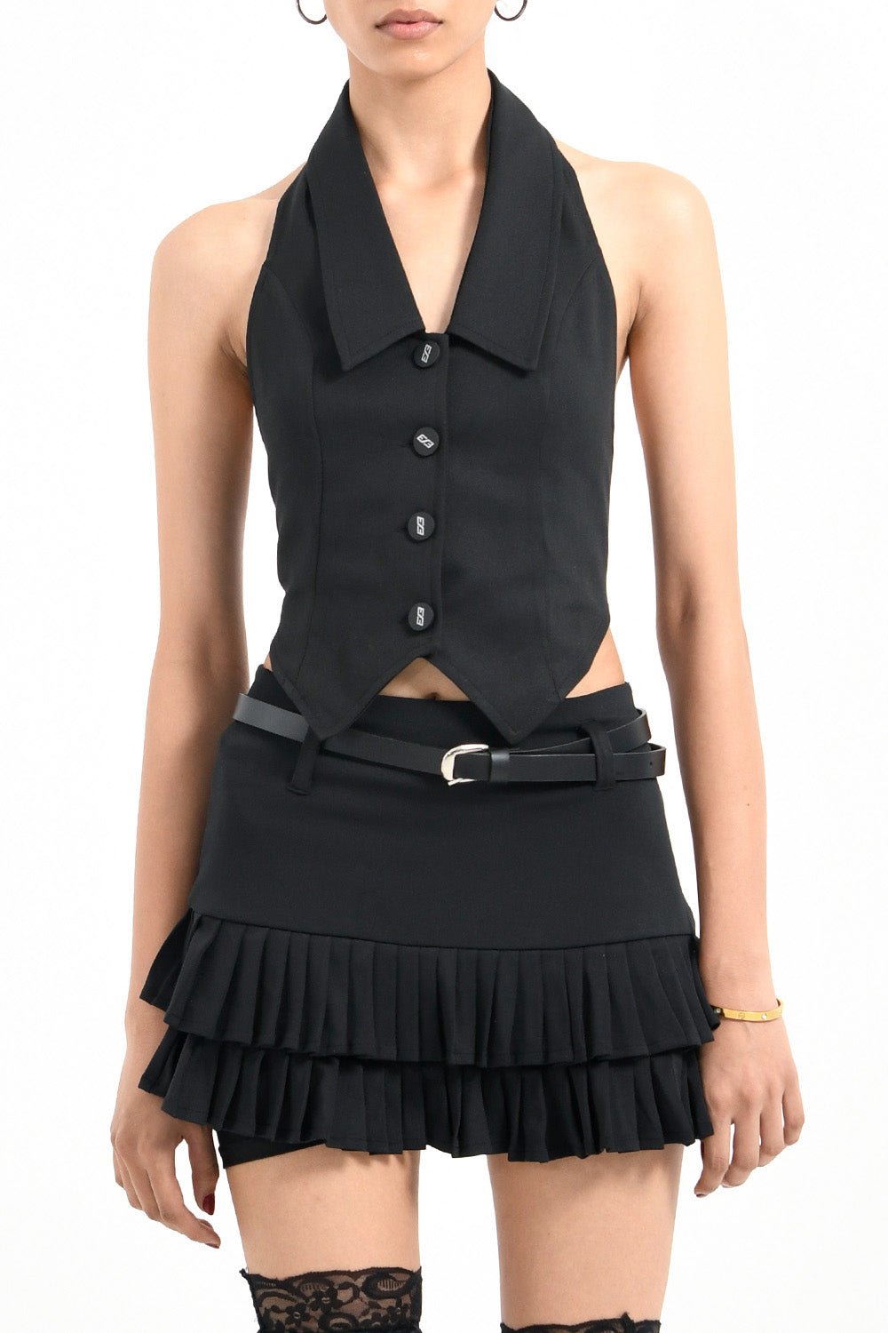 Woman wearing black chilling mini skirt for women by Beeglee – fitted waist and A-line silhouette with pleated design.