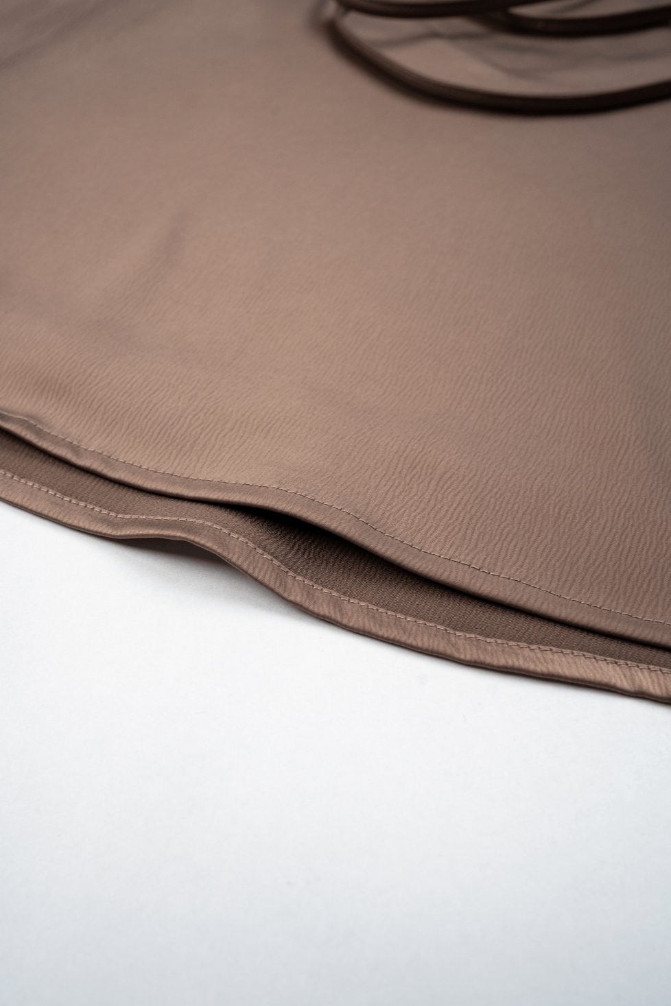 Woman wearing a Dusty rose satin backless mini dress from Beeglee.