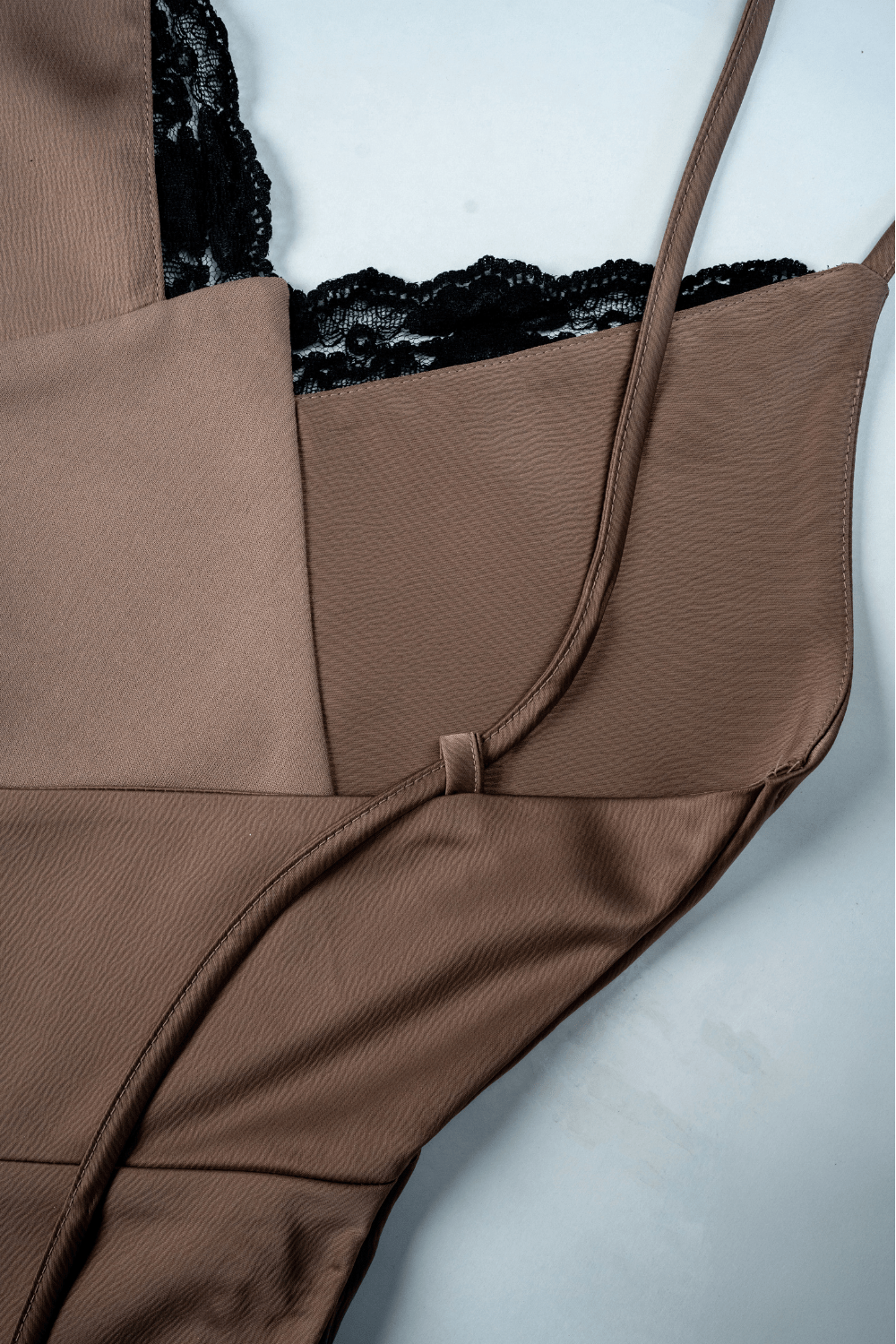 Woman wearing a Dusty rose satin backless mini dress from Beeglee.