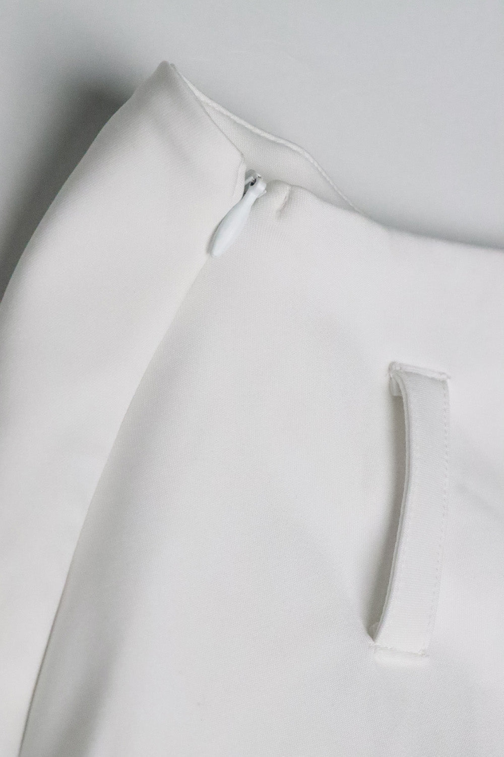 The White chilling mini skirt for women by Beeglee – fitted waist and A-line silhouette with pleated design.