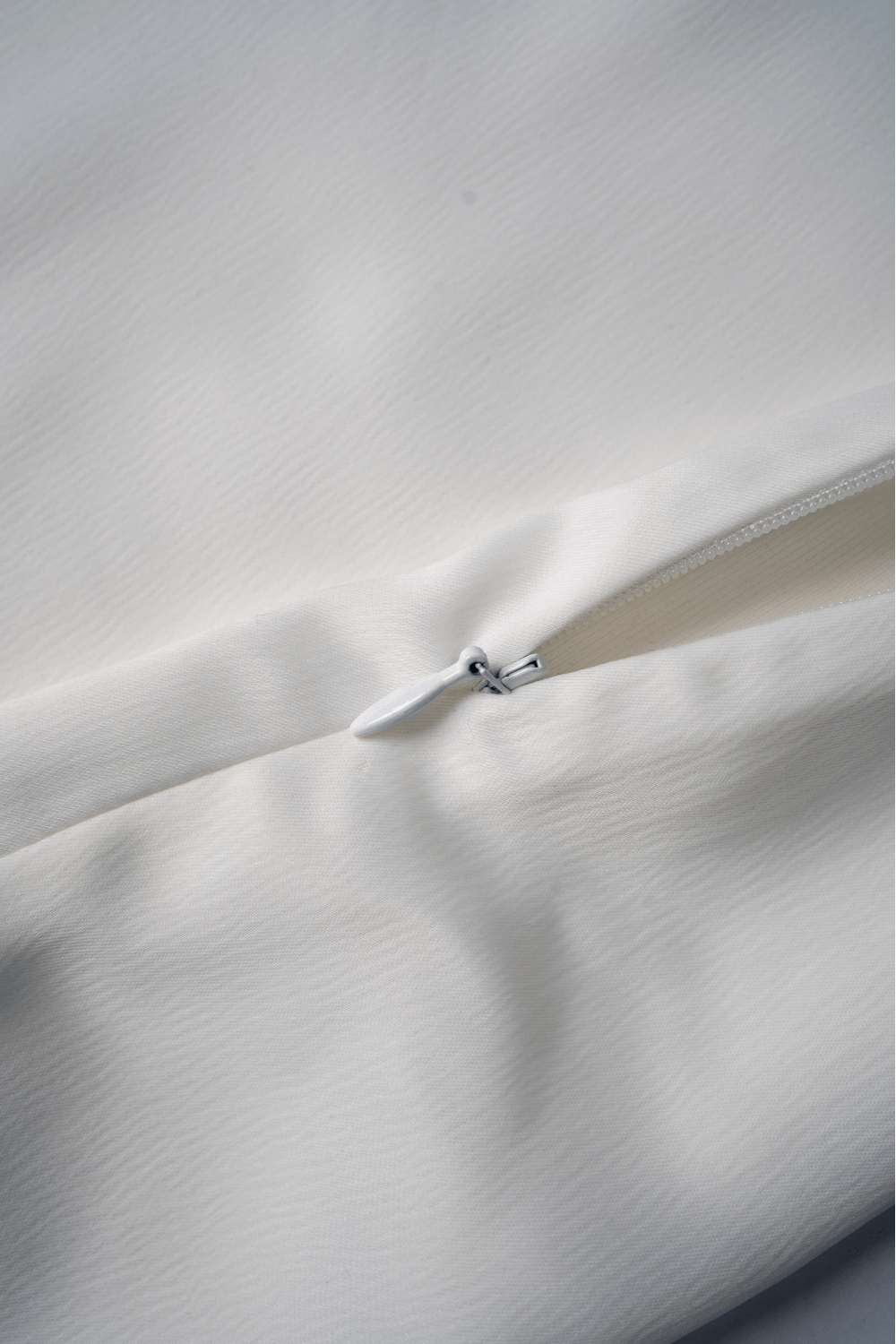 women wearing a sleeveless white satin mini dress – party wear from Beeglee